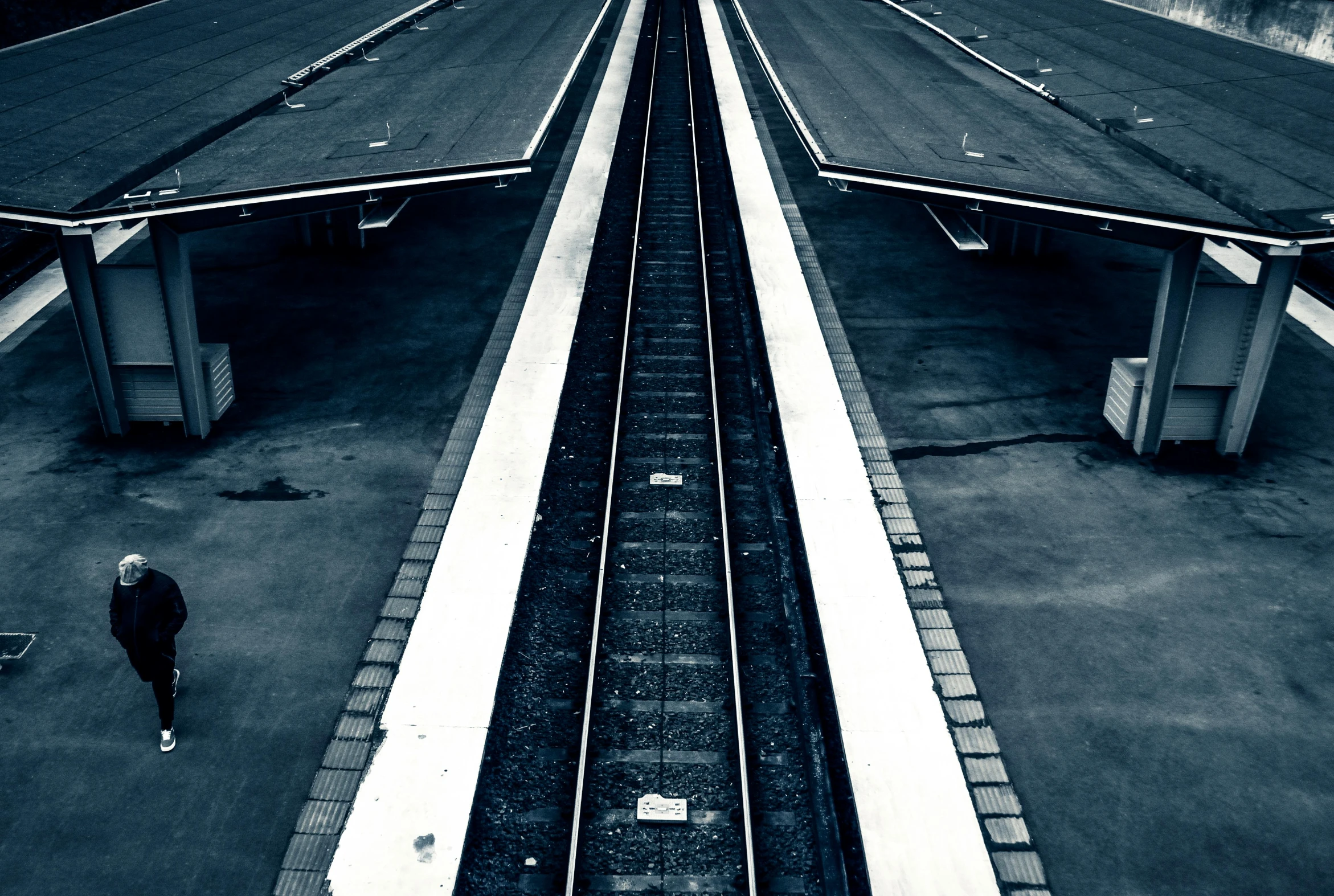 a black and white photo of a train station, unsplash, postminimalism, thick blue lines, high view, square lines, taken in the late 2000s