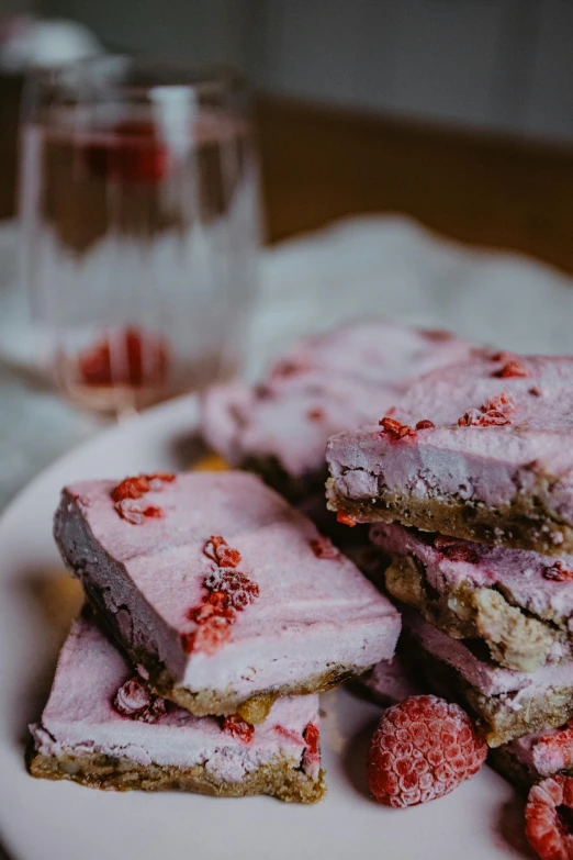 a close up of a plate of food on a table, raspberry, frosted, bar, pinks