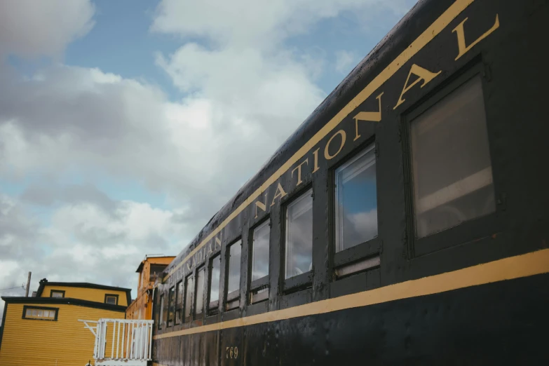 a train with windows sits on the tracks