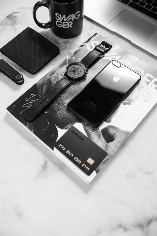 a magazine sitting on top of a table next to a laptop, a black and white photo, by Sebastian Vrancx, trending on pexels, iphone wallpaper, exquisite black accessories, time, behance lemanoosh