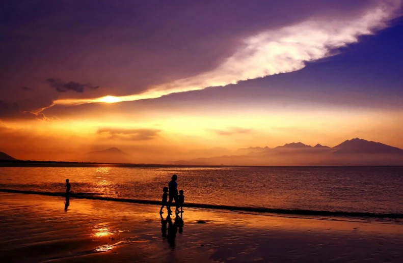 a group of people walking along a beach at sunset, by Jan Tengnagel, pexels contest winner, bali, violet and yellow sunset, thumbnail, family