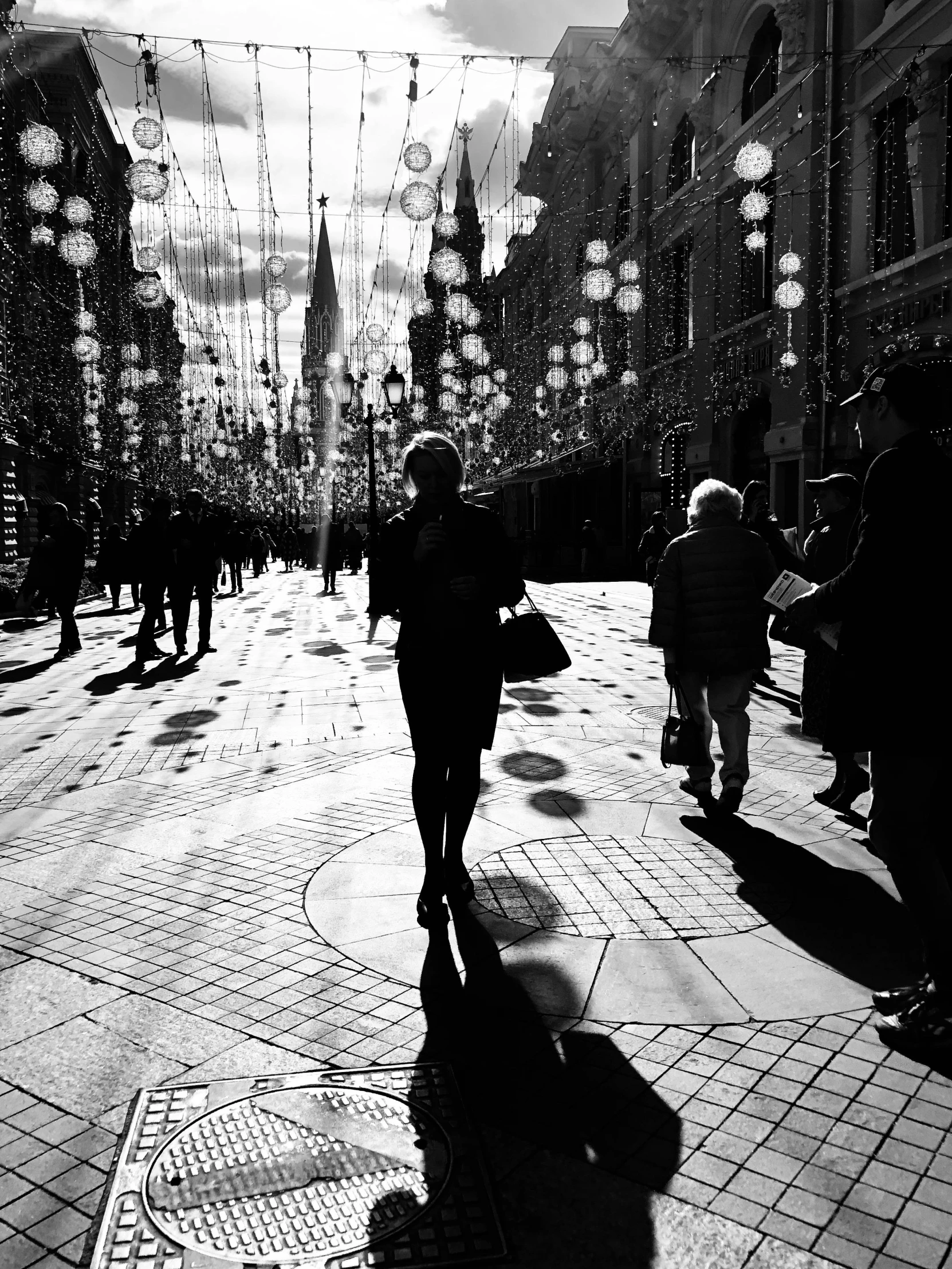 a black and white photo of people walking down a street, by andrei riabovitchev, light and space, woman silhouette, high contrast!!, sergey krasovskiy, by greg rutkowski