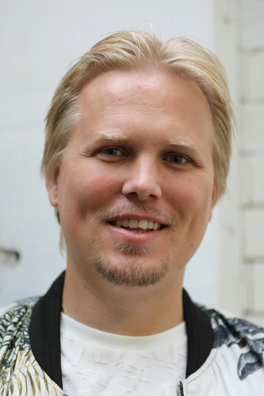 a young man is smiling for the camera