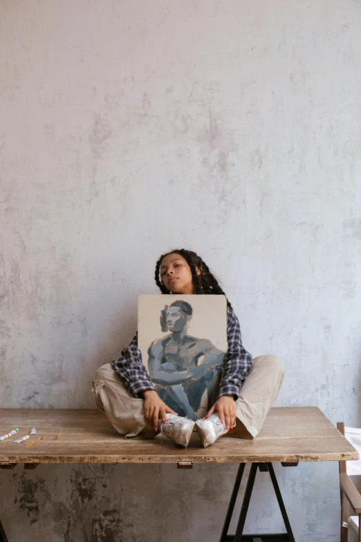 a woman sitting on top of a wooden table, a painting, pexels contest winner, black arts movement, 144x144 canvas, sitting on the floor, woman holding sign, full face and body portrait