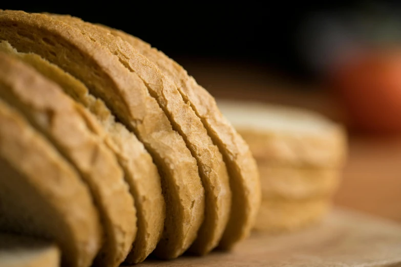 a close - up po shows several round pieces of bread sitting on a  board