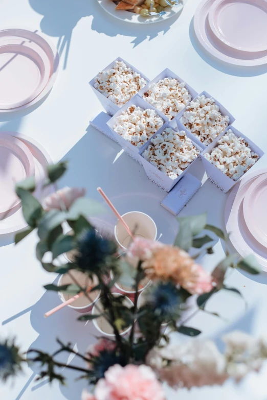 there is a bowl of cereal, plates and a vase with flowers