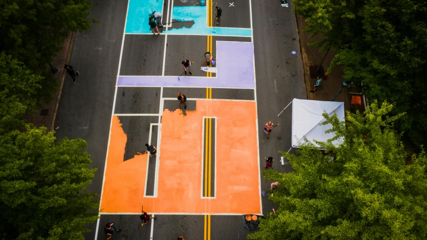 an aerial view of a basketball court surrounded by trees, chalk art, by Meredith Dillman, unsplash contest winner, street art, orange and turquoise and purple, public works mural, block party, some of the blacktop is showing