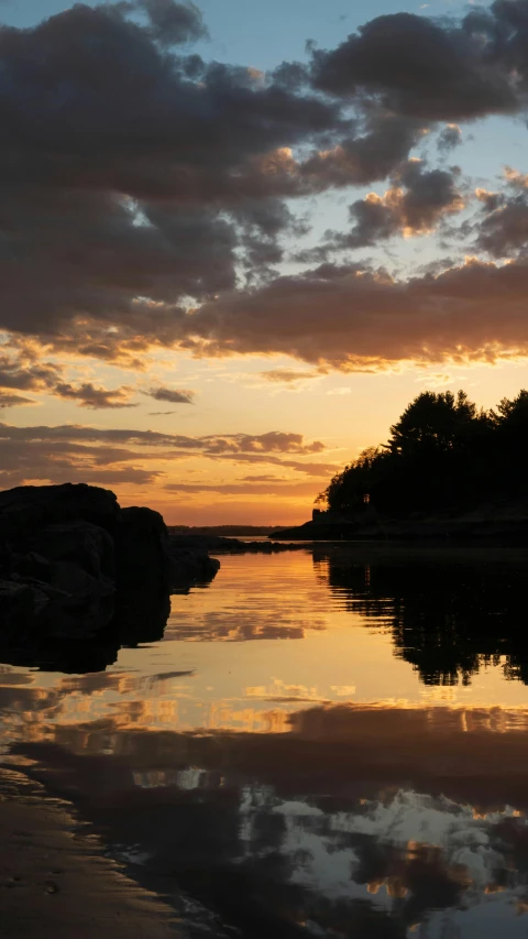 the sun is setting over a body of water, by Ejnar Nielsen, ap art, finland, reflects, coastline