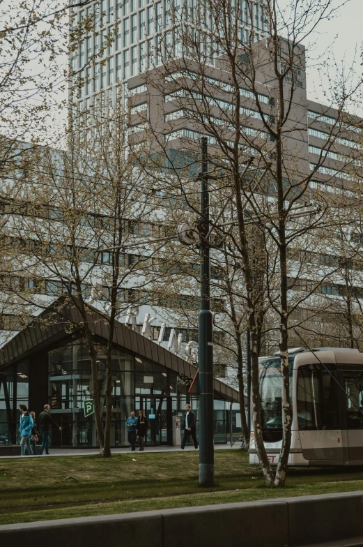 a modern commuter bus parked in front of an office building