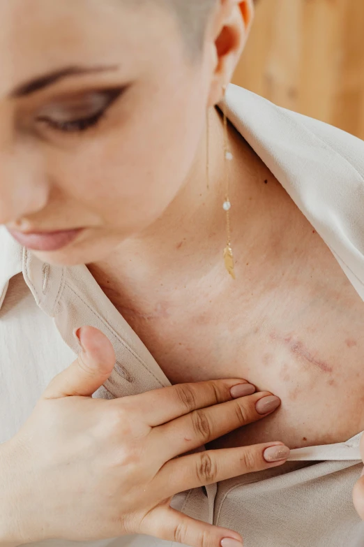 a woman with large  holding her hand to her chest