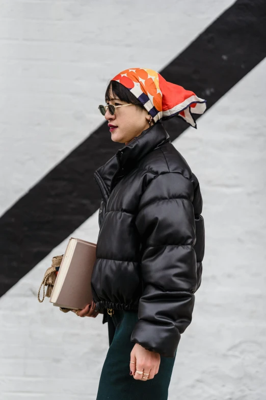 a woman walking down the street carrying a purse, trending on pexels, pop art, model wears a puffer jacket, with black beanie on head, sangsoo jeong, humans of new york style