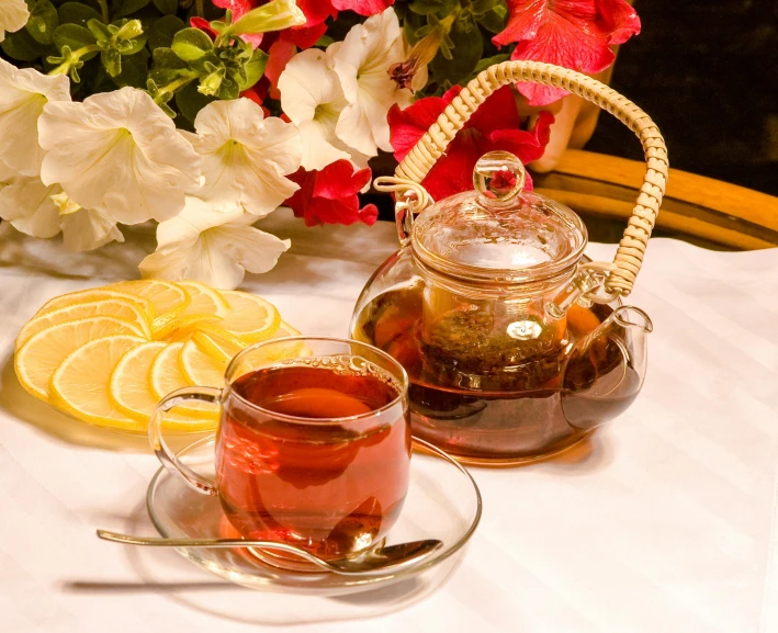 a tea pot sitting on top of a table next to a cup of tea, iced tea glass, thumbnail, high quality product image”, on display