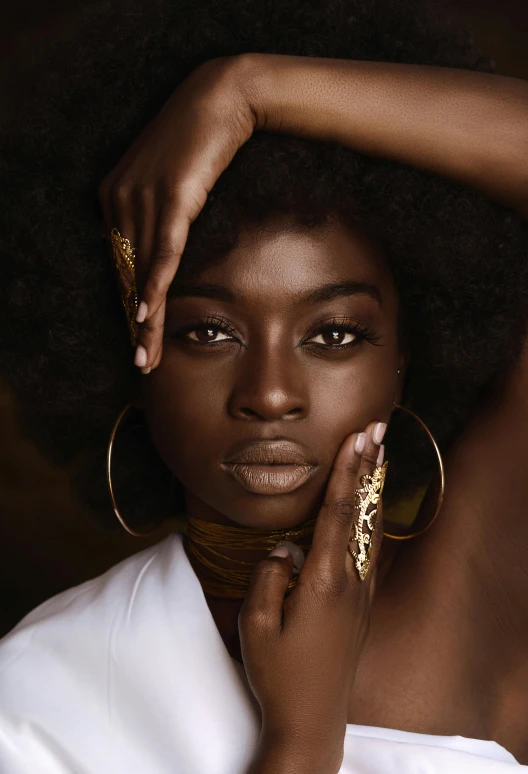 a woman is posing with her hands on her head, trending on pexels, afrofuturism, draped in silky gold, ( brown skin ), jewelry photography, afro hair