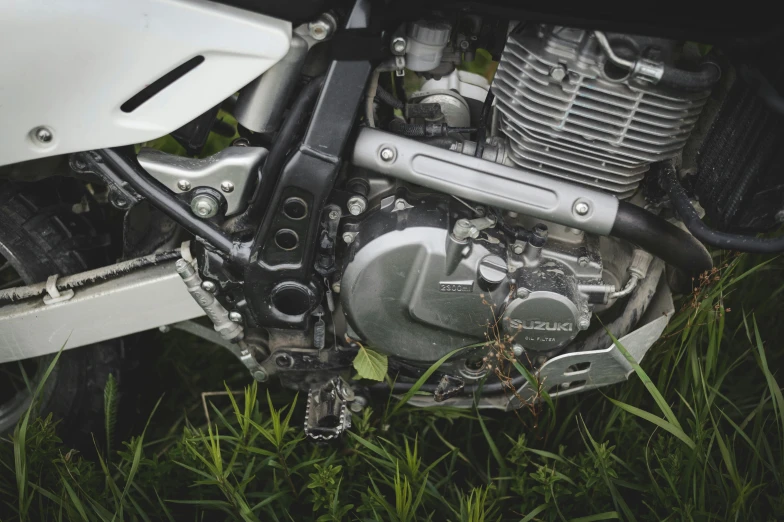 a motorcycle that is sitting in the grass, by Daniel Lieske, unsplash, white mechanical details, off - road, ureal engine, 🚿🗝📝