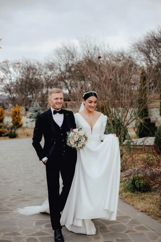 a man in a tuxedo and a woman in a wedding dress, 2019 trending photo, daniil kudriavtsev, park in background, february)