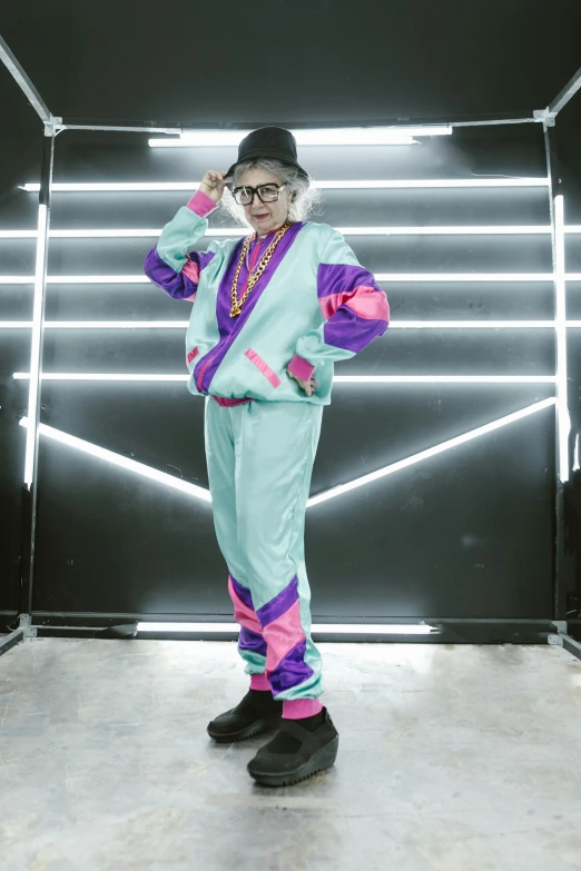 a person standing in a room with neon lights, wearing a track suit, grandma, costume, mint higlights