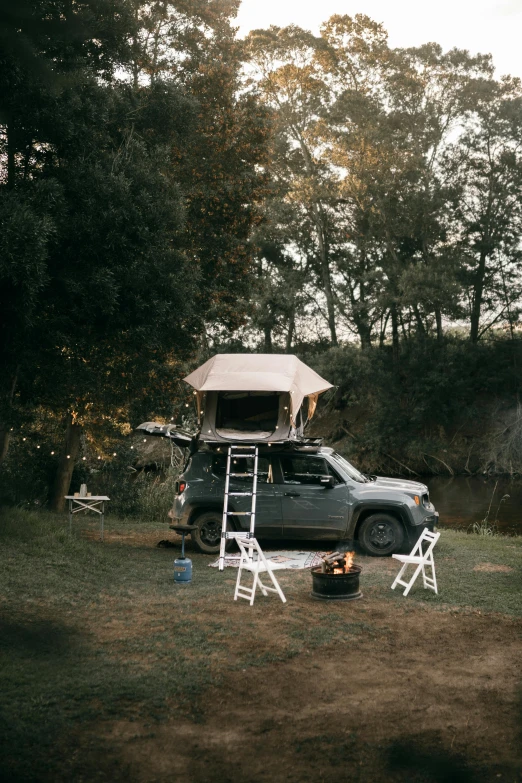 a truck that is parked in the grass, unsplash, renaissance, barrel fires and tents, jeep, with a bunk bed, fullbody view