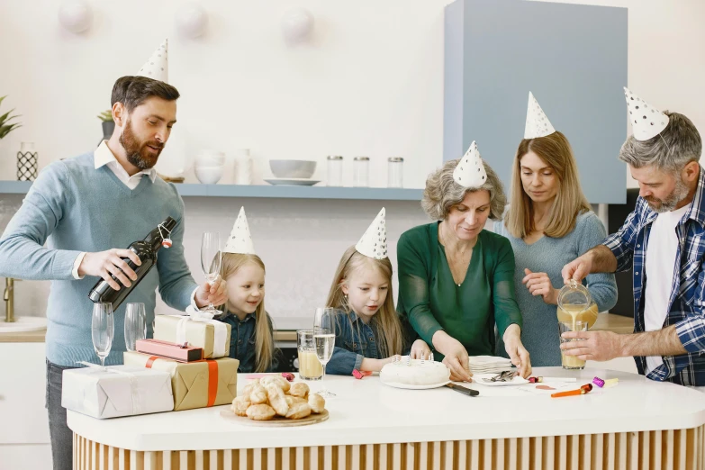 a group of people standing around a kitchen table, inspired by Hendrick Avercamp, pexels contest winner, private press, party hats, happy family, profile image, promotional image