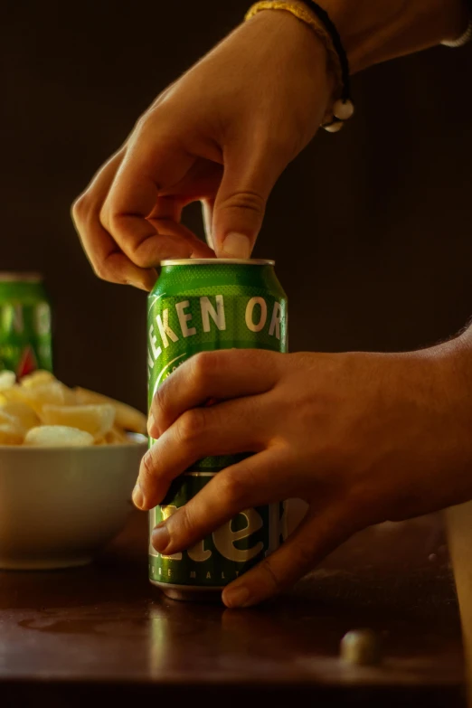 a person is squeezing a can of green beer into a bowl