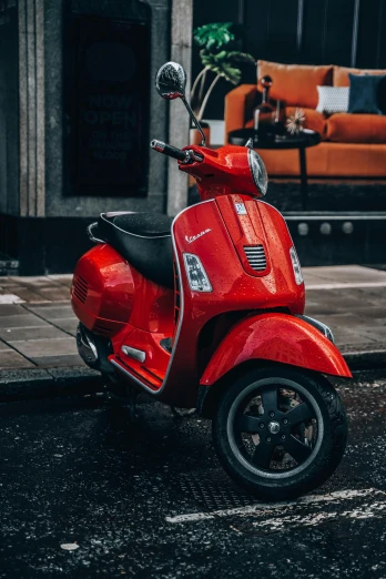 a red scooter sitting on the side of a road