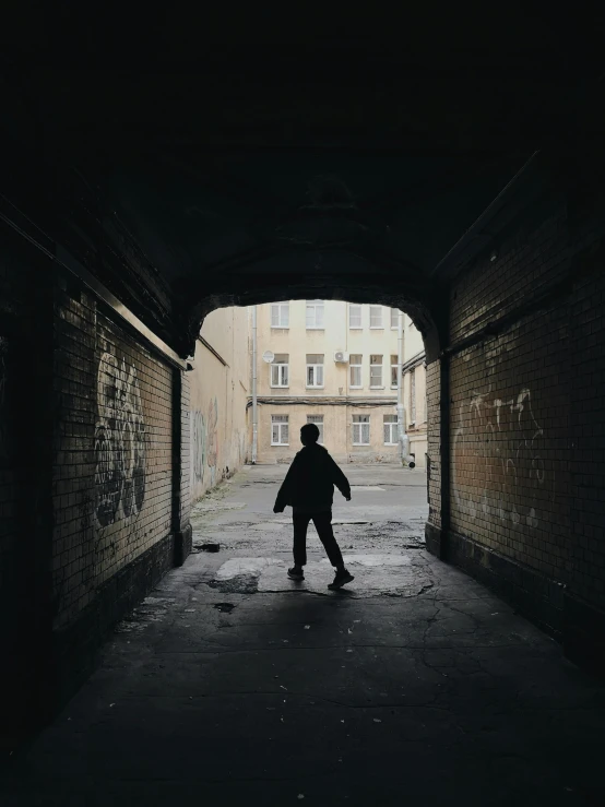 a person in a dark tunnel with a skateboard, by Christen Dalsgaard, post - soviet courtyard, childhood friend, standing in a city center, stockphoto