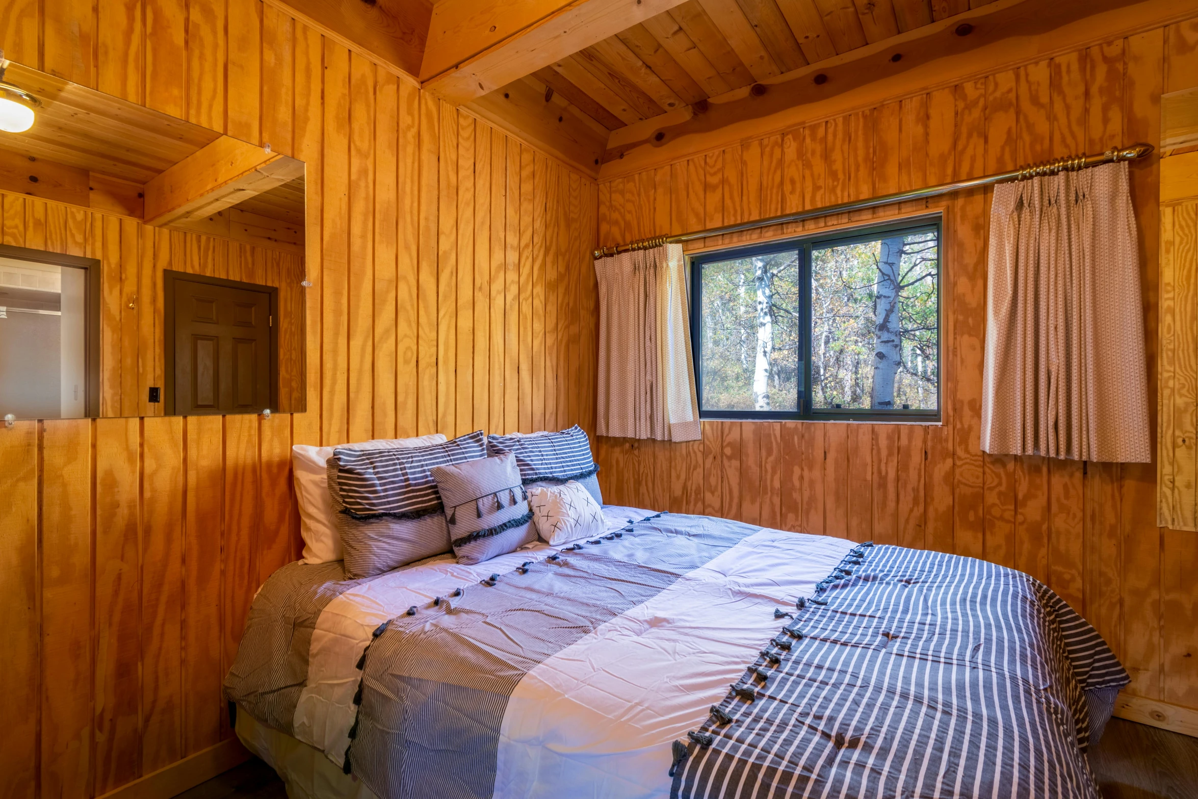 a bed in a bedroom with wood walls