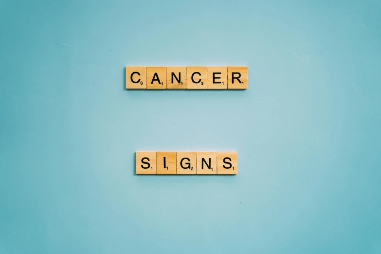 scrabbles spelling cancer and signs on a blue background, pexels, old signs, 1 6 x 1 6, amber, star charts