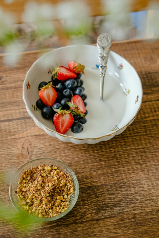 a bowl of granola with strawberries and blueberries, renaissance, curated collection, porcelain organic, gold flakes, in detail