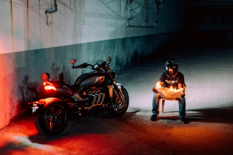 a person sitting in a chair next to a motorcycle