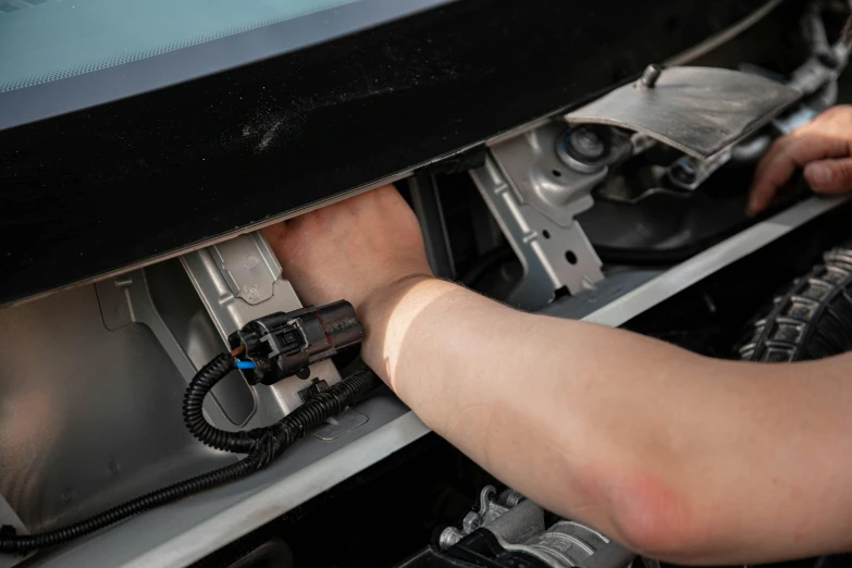 a close up of a person working on a machine, front of car angle, usb ports, detailed product image, half image