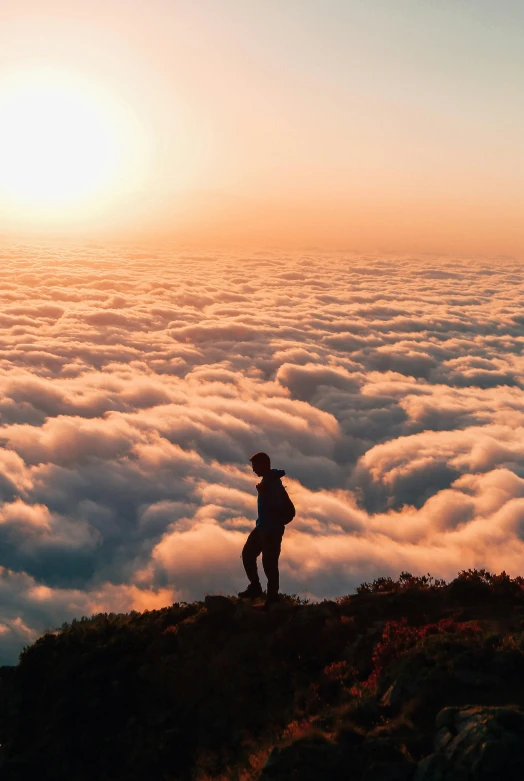 a man standing on top of a mountain above the clouds, by Niko Henrichon, pexels contest winner, full body profile, sunset clouds, calmly conversing 8k, san francisco