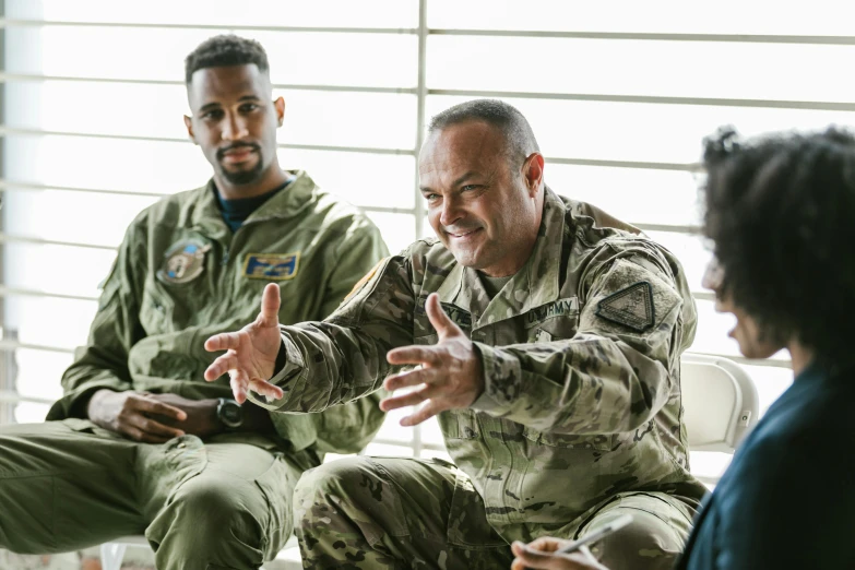 a group of people sitting around each other, airforce gear, chris scalf, teaching, temuera morrison