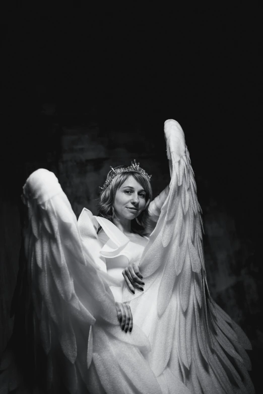 a black and white photo of an angel, pexels contest winner, renaissance, posing as a queen, big white glowing wings, angelina stroganova, 2010s