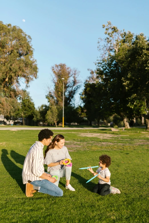 a family playing with a kite in a park, pexels contest winner, conceptual art, los angeles ca, square, low quality photo, fairy circles