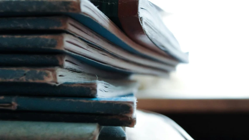 a stack of books sitting on top of a table, blue archive, up-close, battered, thumbnail