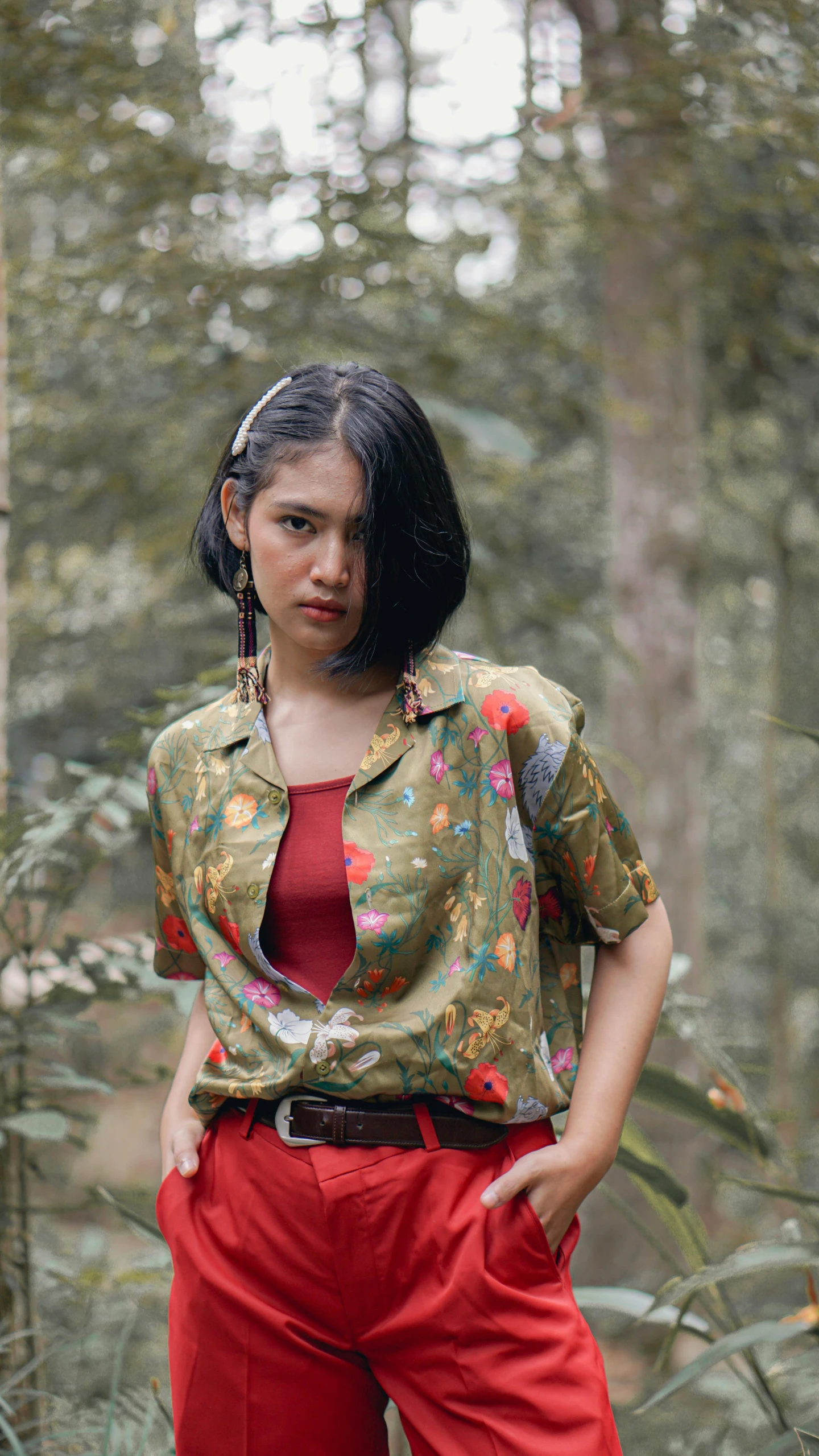 a woman standing in the middle of a forest, an album cover, by Basuki Abdullah, trending on pexels, vintage shirt, batik, olive, croptop