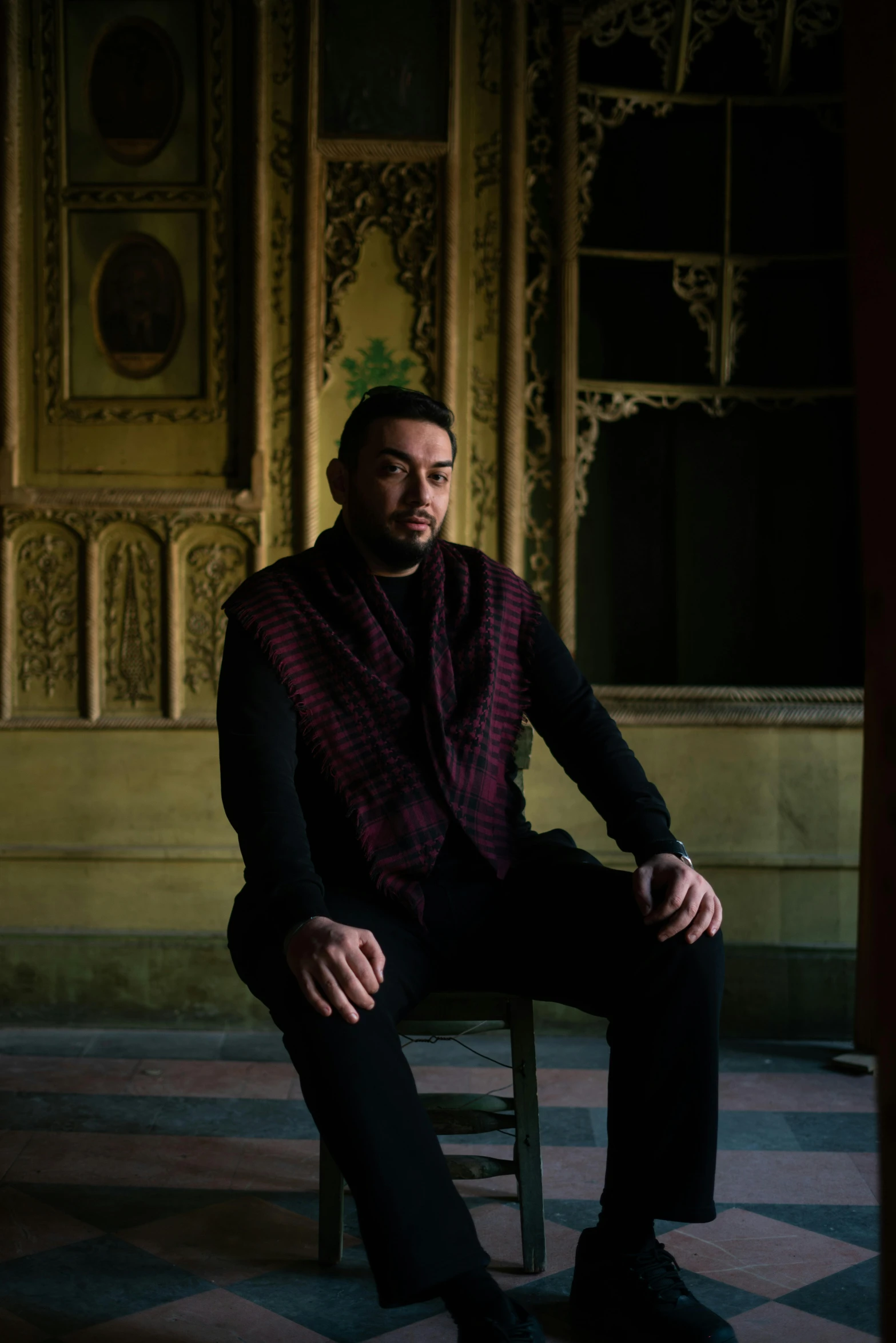 a man sitting on a chair in a room, an album cover, inspired by Luis Paret y Alcazar, pexels contest winner, renaissance, standing inside of a church, samarkand, masculine and handsome, artem chebokha
