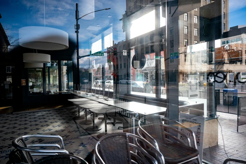 an outside cafe with tables and chairs in the background