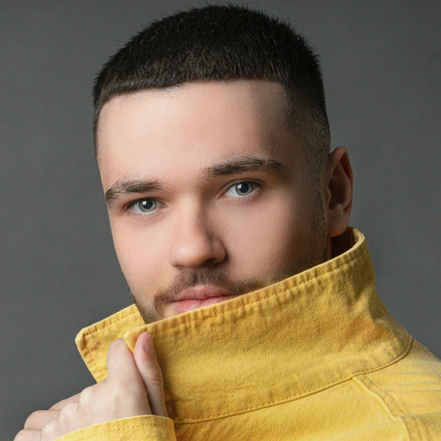 a man in a yellow jacket posing for a picture, inspired by Vasile Hutopila, trending on reddit, crew cut hair, ukraine. professional photo, acting headshot, square masculine jaw