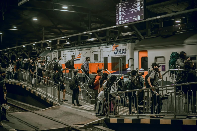 a crowd of people is standing in front of a train