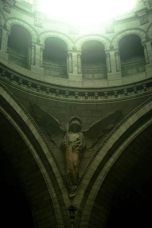 a clock that is on the side of a building, a statue, cathedral ceiling, volumetric lighting - n 9, old gothic crypt, ethereal wings