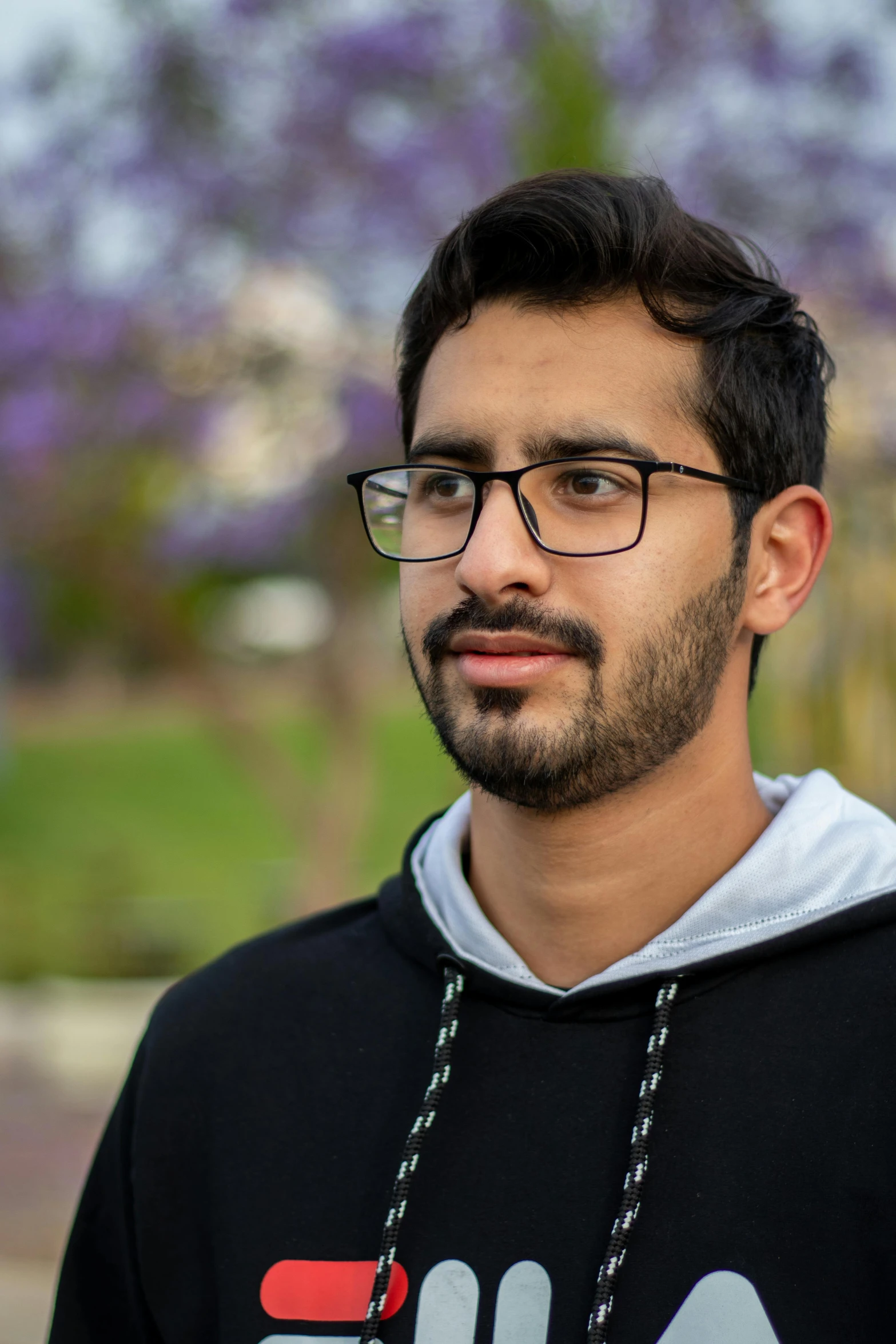 a man in a black hoodie looking away