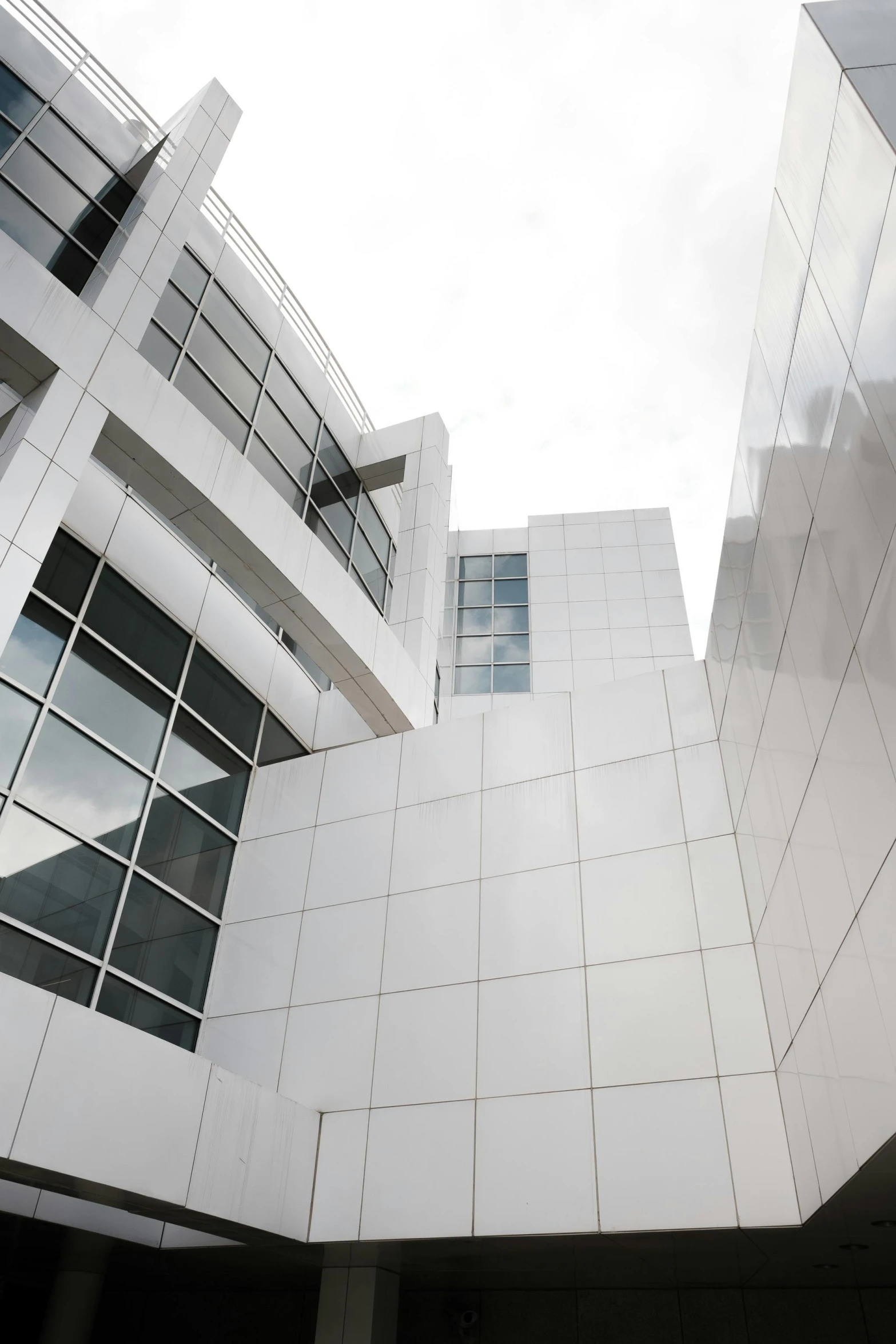 a man riding a skateboard up the side of a building, inspired by Bauhaus, unsplash, bauhaus, made of all white ceramic tiles, medical research facility, windows and walls :5, frank gehry