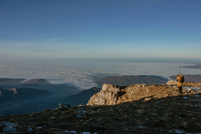 a man on top of a hill with snow