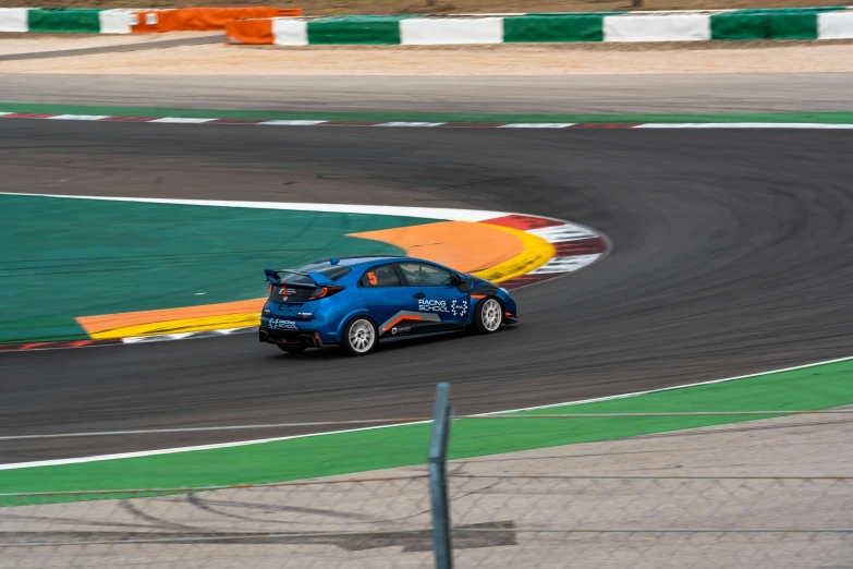 a small car racing around the track, as if from behind