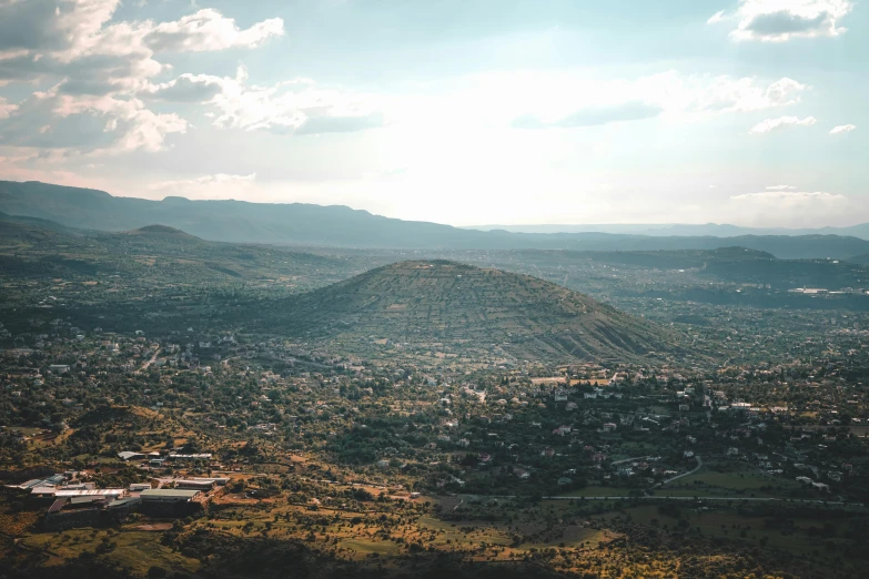 an aerial view of a rural city in the mountains