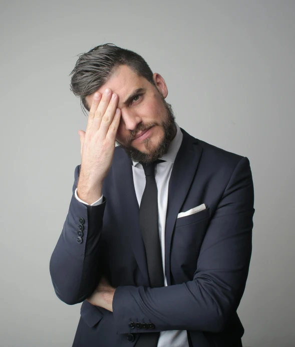 a man in a suit holding his hands to his face, an album cover, pexels, scruffy man, disappointed, ryan dening, alex trebek