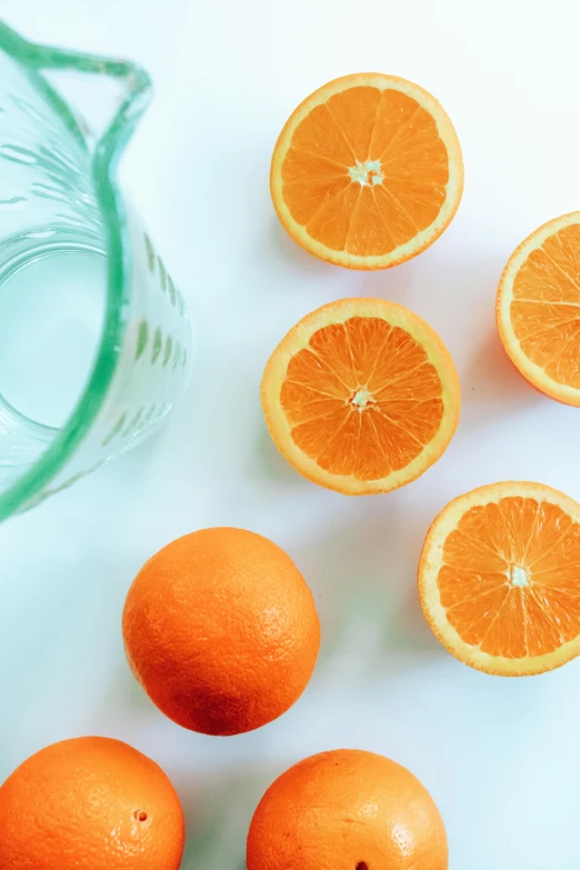 a bunch of oranges sitting on top of a table, by Carey Morris, pexels contest winner, sparkling water, inside a glass jar, white background and fill, split - complementary - colors