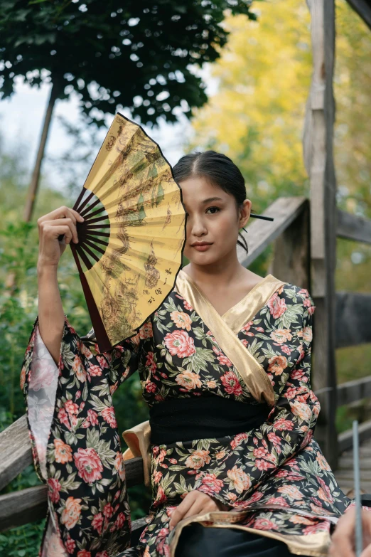 a woman is holding an oriental umbrella while posing for the camera