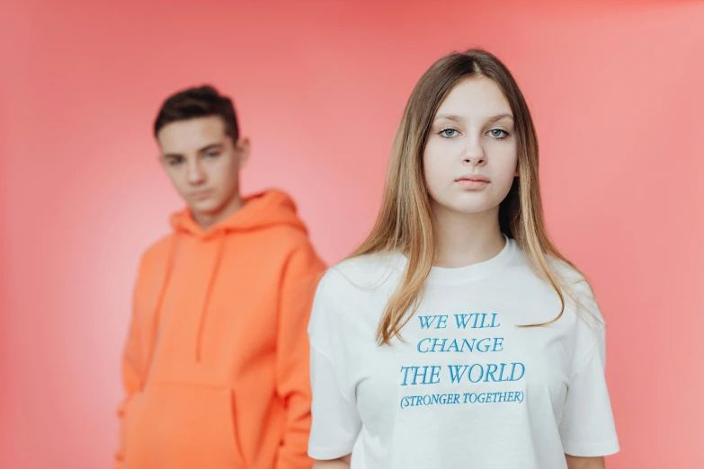 a couple of people standing next to each other, trending on pexels, antipodeans, greta thunberg, off - white collection, white and orange, world peace